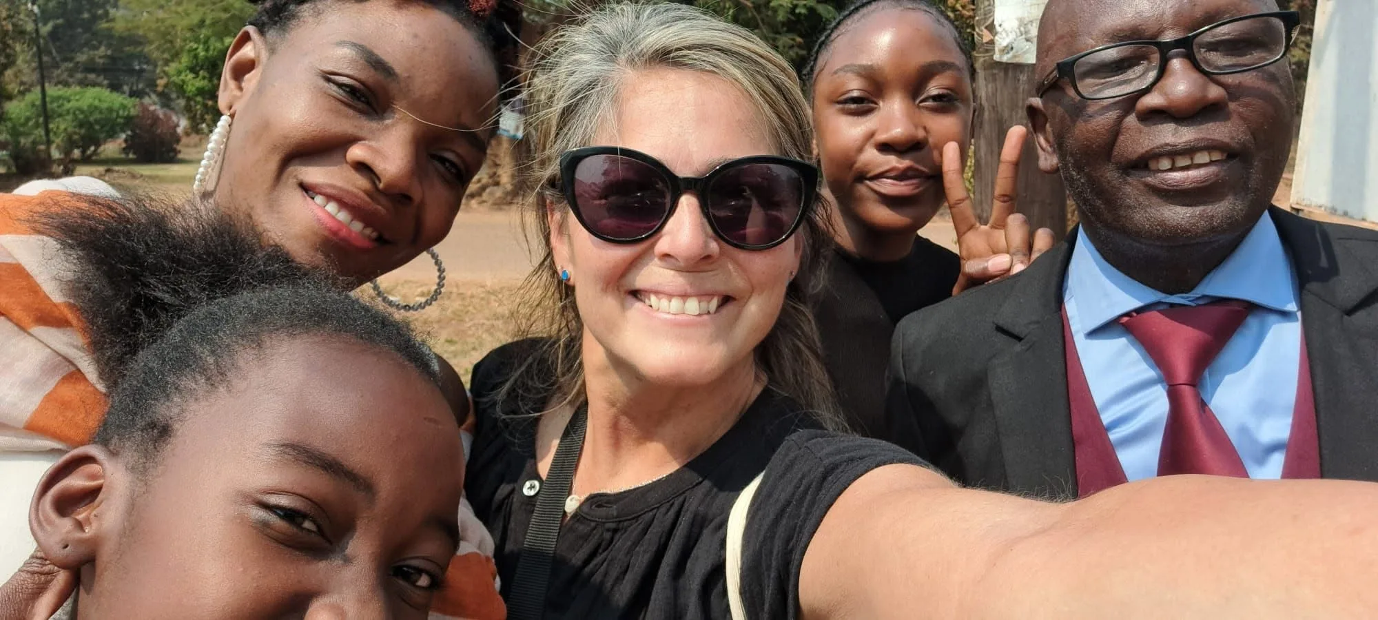 Terra smiling in a group selfie with friends during her time in Africa